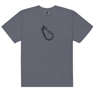 May include: A slate gray t-shirt featuring a black carabiner graphic. The short-sleeved shirt has a crew neck and a relaxed fit. The carabiner is a simple line drawing, centered on the chest.