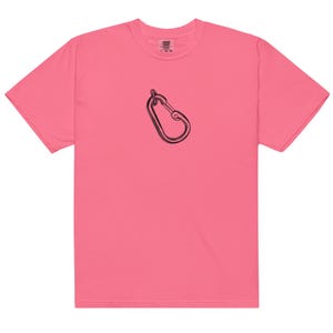 May include: A vibrant pink t-shirt featuring a black line drawing of a carabiner. The short-sleeved shirt has a crew neck and a relaxed fit. The carabiner graphic is centered on the chest.