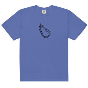 May include: A periwinkle blue t-shirt featuring a black carabiner graphic. The short-sleeved shirt has a crew neck and a relaxed fit. The carabiner is a climbing accessory, often used for connecting ropes and other gear.
