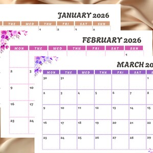 May include: A set of three 2026 calendars, each displaying a different month: January, February, and March. The calendars feature a white background with purple and pink floral accents. The days of the week are listed across the top.