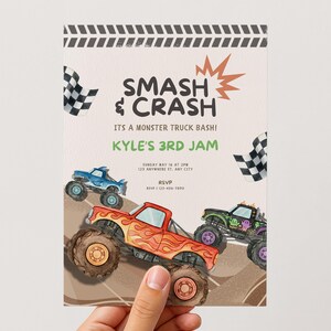 May include: A party invitation with the text "SMASH & CRASH" and "KYLE'S 3RD JAM". The design features illustrations of monster trucks in red, blue, and black, with checkered flags and a brown background.