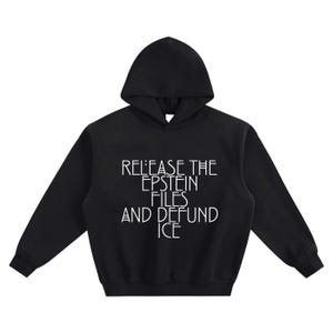 May include: Black hooded sweatshirt with white text that reads "RELEASE THE EPSTEIN FILES AND DEFUND ICE". The sweatshirt has long sleeves and a drawstring hood. The text is centered on the front of the garment.