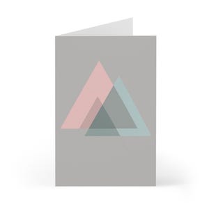 May include: A white ceramic mug with a black handle and the text "But First, Coffee" in a black, bold font. The mug is on a white surface.