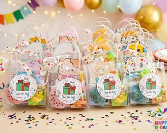 May include: A collection of clear plastic gift bags with white handles, each tied with a colorful balloon-patterned ribbon. A round sticker on the front features a brown bear and a white rabbit in a green gift box with the text Just for You.