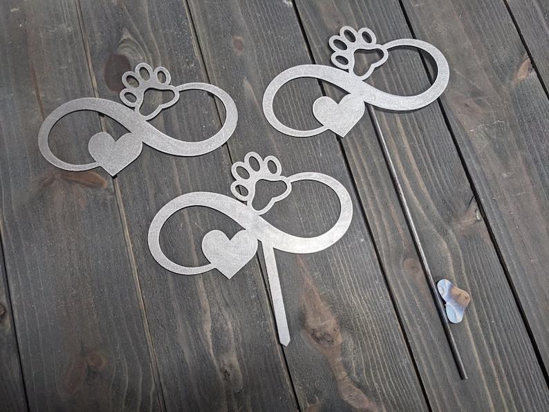 Examples of the variations of the Infiniti dog paw garden stake. options include the Infiniti dog paw metal sign without a stake, with a short stake, and with a longer welded stake. personalization options are also available.