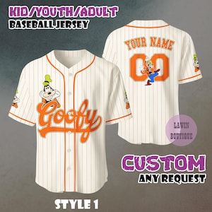 May include: Cream-colored baseball jersey with orange pinstripes and accents. Features the word "Goofy" in orange script on the front and a cartoon image of Goofy. The back has the text "YOUR NAME" and the number "00".