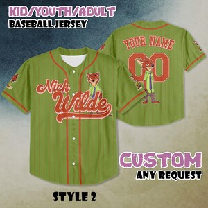 May include: Green baseball jersey with red pinstripes, featuring the text "Nick Wilde" in a stylized font. The jersey has a cartoon fox graphic and the text "YOUR NAME" and a number on the back. The text "KID/YOUTH/ADULT BASEBALL JERSEY" is at the top.