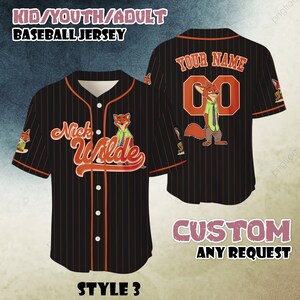 May include: Black baseball jersey with orange pinstripes, featuring "Nick Wilde" text and a fox graphic. The jersey includes the text "YOUR NAME" and "00" on the back, with the words "CUSTOM ANY REQUEST" at the bottom. The jersey is labeled "STYLE 3".