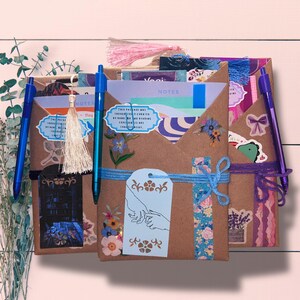 Blind Date with a Book | Blind Dates with Books Collection | Mystery Book Gift | Book Lover Gift | Bookish Gift | Reader Gift | Book Gift Box | Curated Reading Experience featuring a beautifully wrapped mystery book in brown kraft paper tied with twine, with bookmarks, bookish stickers, reading accessories, paper treasures, stationery, journaling supplies, annotation tabs, and thoughtful gifts for readers, book clubs, birthdays, holidays, Christmas, and self-care.