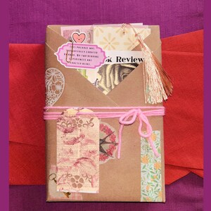 Blind Date with a Book | Blind Dates with Books Collection | Mystery Book Gift | Book Lover Gift | Bookish Gift | Reader Gift | Book Gift Box | Curated Reading Experience featuring a beautifully wrapped mystery book in brown kraft paper tied with twine, with bookmarks, bookish stickers, reading accessories, paper treasures, stationery, journaling supplies, annotation tabs, and thoughtful gifts for readers, book clubs, birthdays, holidays, Christmas, and self-care.