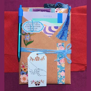Blind Date with a Book | Blind Dates with Books Collection | Mystery Book Gift | Book Lover Gift | Bookish Gift | Reader Gift | Book Gift Box | Curated Reading Experience featuring a beautifully wrapped mystery book in brown kraft paper tied with twine, with bookmarks, bookish stickers, reading accessories, paper treasures, stationery, journaling supplies, annotation tabs, and thoughtful gifts for readers, book clubs, birthdays, holidays, Christmas, and self-care.