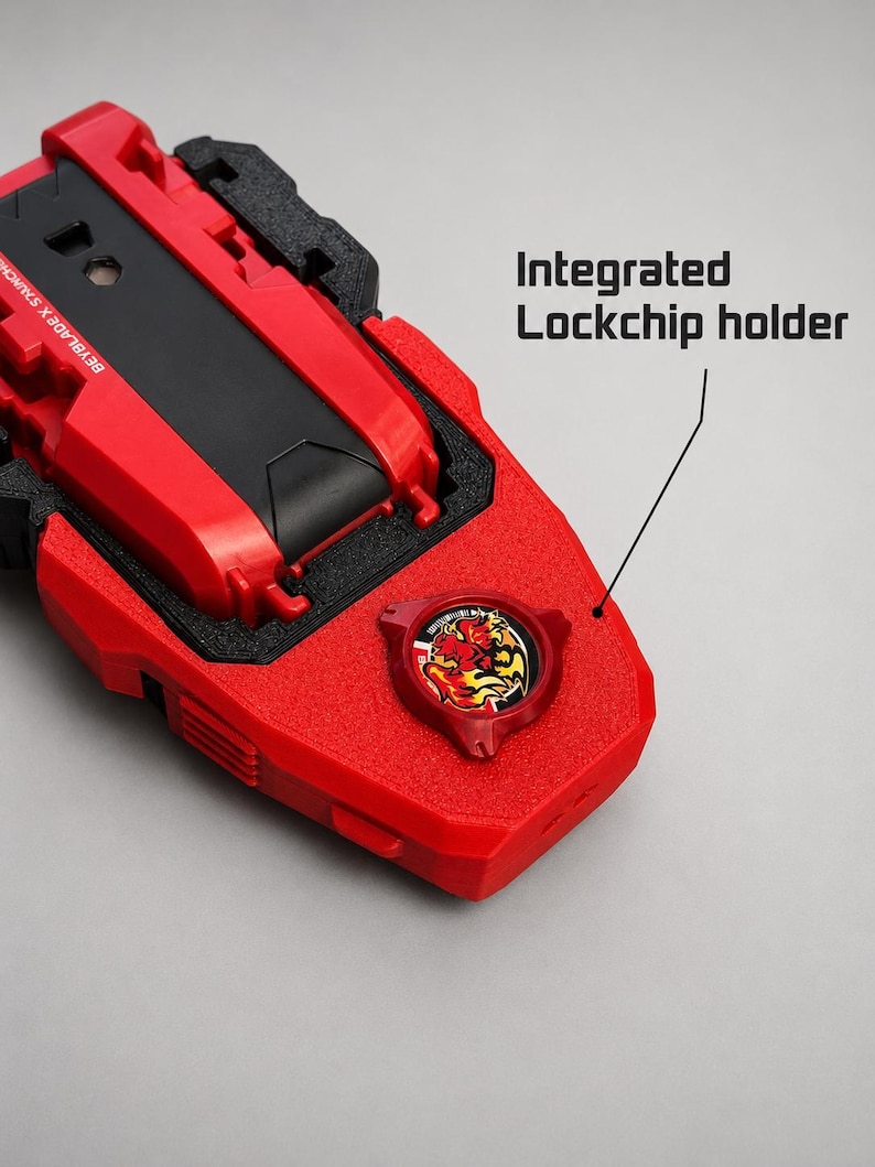 May include: A red and black Beyblade X launcher featuring an integrated lockchip holder. The device has a textured red plastic body with a circular emblem displaying a stylised flame graphic. The text BEYBLADE X LAUNCHER is visible on the side.