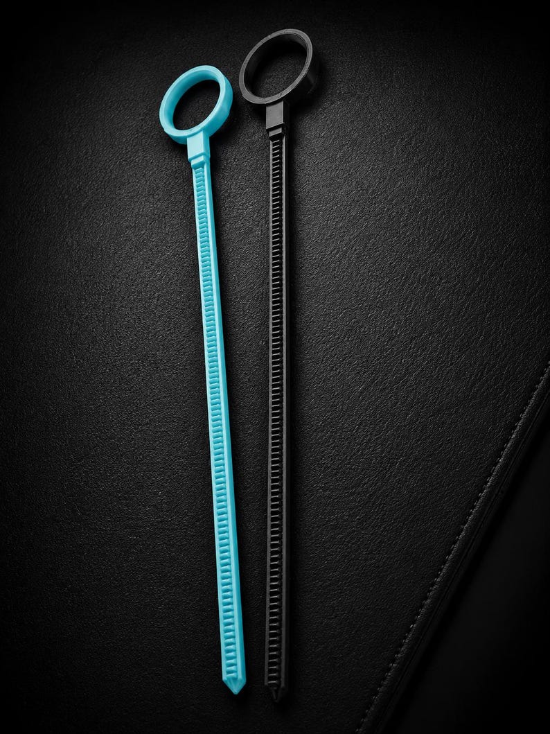 May include: Two cable ties, one light blue and one black, are displayed against a black background. Each tie has a circular head and a long, ridged body. The light blue tie is on the left, and the black tie is on the right.