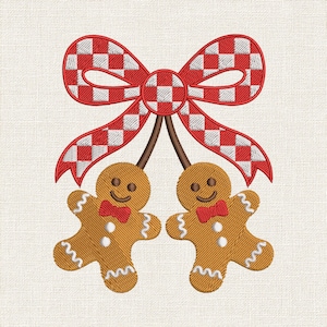 May include: An embroidery design featuring two brown gingerbread figures with white icing details and red bow ties, suspended from brown stems attached to a large red and white chequered bow with a matching red border on a textured fabric background.