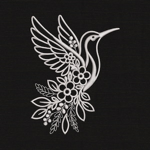 May include: A white embroidered design of a hummingbird in flight on a black background. The bird is composed of stylized floral patterns, leaves, and small berries integrated into its wings and body, creating a cohesive botanical illustration.