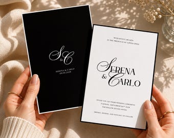 May include: Two wedding invitations, one black and one white, are held up. The black invitation has white text with the initials "S&C" and the date "09.10.2028". The white invitation has the names "Serena & Carlo" and wedding details.