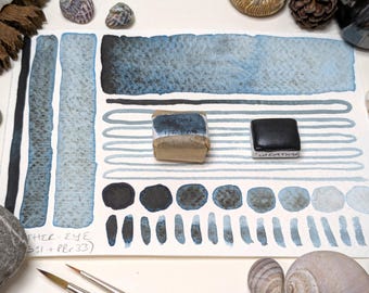 Weather eye: dark blue with brown-black granulation. Handmade granulating watercolour paint in 3 pan sizes made with vegan watercolor binder