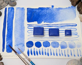 Cloudless: a soft, granulating sky blue for summer. Handmade watercolour paint in 3 pan sizes, made with vegan watercolor binder.