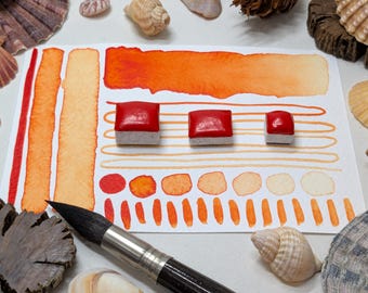 Red-orange glow: handmade red-leaning orange watercolour paint, in half or quarter pans, made with vegan watercolor binder