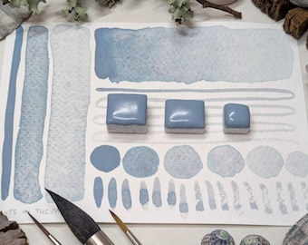 Lights in the mist: pale blue granulating handmade watercolour paint with colourful undertones. Vegan watercolor paints in half/quarter pans