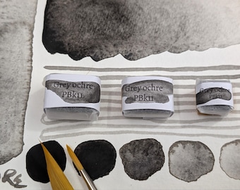 Grey ochre PBk11: a dark, granulating, natural iron oxide gray handmade watercolour paint. In 3 pan sizes. Vegan watercolor binder.