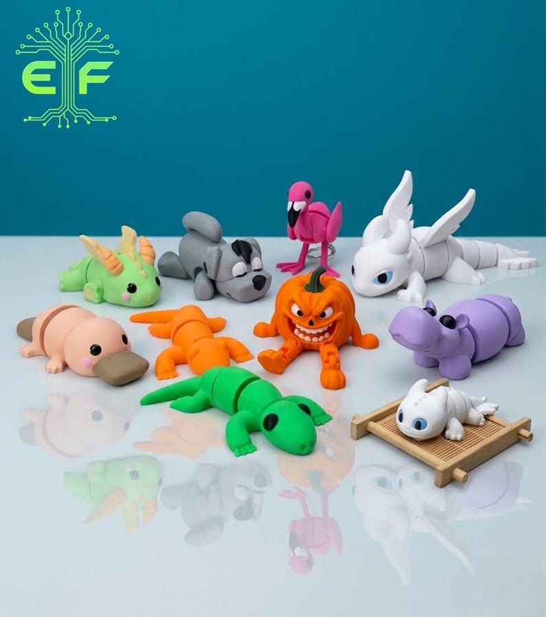 May include: A collection of colorful, whimsical figurines. The assortment includes a green lizard, a pink flamingo, a purple hippo, a white dragon, and a smiling orange pumpkin. Other figures include a platypus and a gray dog.
