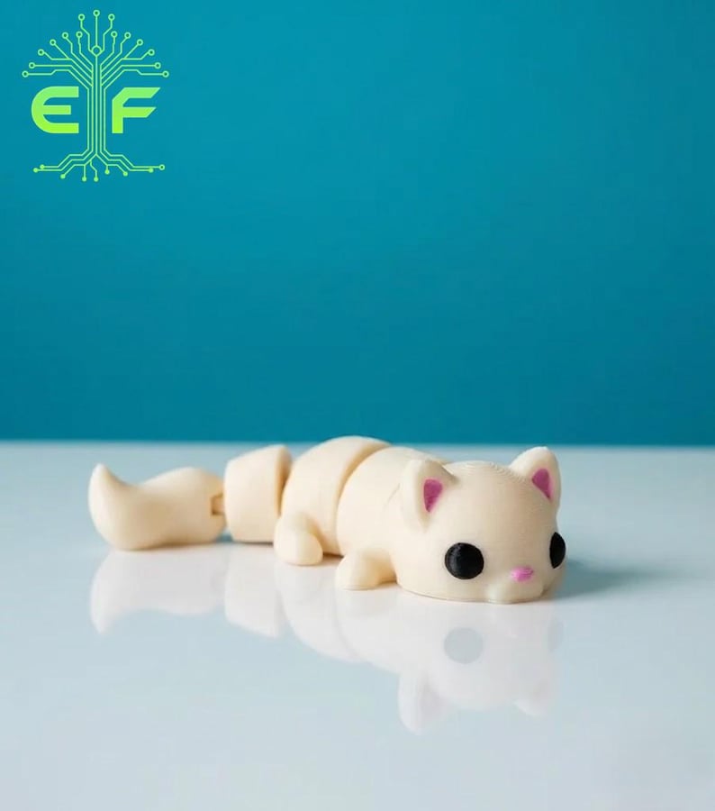 May include: A segmented, off-white cat figurine with black eyes and pink inner ears and nose. The tail is detached, and the cat is lying down. The background is a solid teal color.
