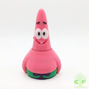 May include: A pink 3D-printed figure of Patrick Star from the animated series Spongebob Squarepants. The figure has a smiling face with white eyes, a single tooth, and a small pink tongue. The figure is wearing green and purple shorts.