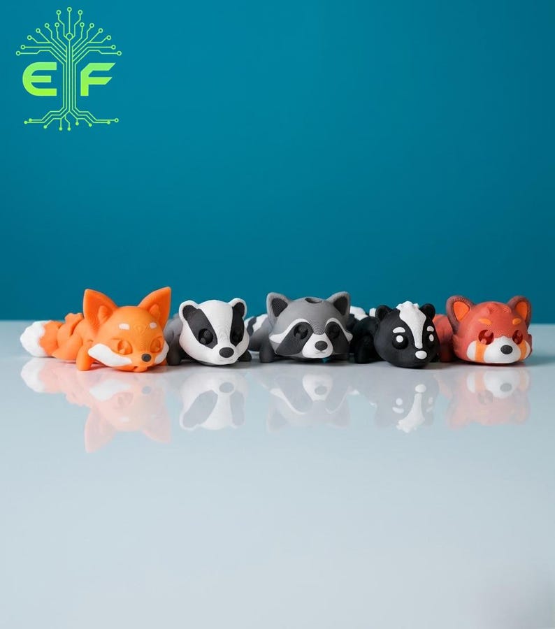 May include: A collection of five animal figurines: a fox, a badger, a raccoon, a skunk, and a red panda. Each figurine is lying down, with detailed features and vibrant colors. The background is a solid teal color, and the figurines are on a white surface.