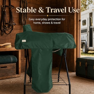 May include: A dark green saddle cover draped over a black metal stand. The cover features a small rectangular label on the side. Text visible on the image includes "Stable & Travel Use" and "Easy everyday protection for home, shows & travel."