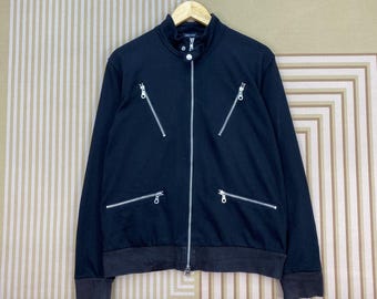 Chaqueta punk con cremallera de la diseñadora japonesa Comme Ca Ism en color negro.