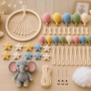 May include: A collection of handmade crochet items, including a gray elephant, colorful balloons, star shapes, and a circular wall hanging. The items are arranged on a light wooden surface, suggesting a nursery or children's room theme.