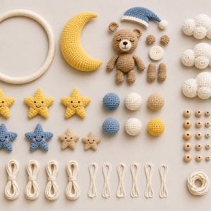 May include: A selection of handmade crochet items, including a teddy bear, crescent moon, stars, clouds, and beads. The colour palette features soft yellows, blues, and creams, ideal for a nursery or baby room. The items are arranged on a neutral background.