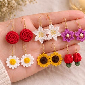 May include: A white ceramic mug with a black handle and the text "But First, Coffee" in a black, handwritten-style font. The mug is on a white surface.