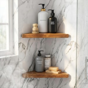 May include: Bathroom shelf display with shampoo, body wash, and shaving cream bottles. A wooden brush, soap, and bath salts are also visible. The bottles are labeled with white text. The shelves are made of wood and are mounted on a marble-patterned wall.