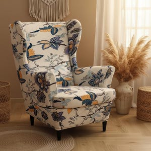 May include: Wingback armchair with a floral pattern in shades of blue, orange, and purple on a cream background. The chair has a high back and black legs, offering a classic and elegant design for home decor.