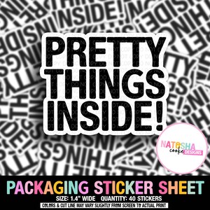 May include: A packaging sticker sheet with the text "PRETTY THINGS INSIDE!" in bold black letters. The sticker sheet also includes the text "PACKAGING STICKER SHEET" and the size of the stickers, which is 1.4 inches wide.