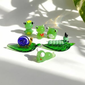 May include: A set of three ceramic mugs with a speckled, matte finish. Each mug is a different colour: light blue, cream, and grey. The mugs have a simple, modern design and a comfortable handle.