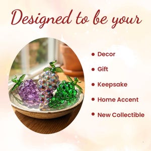 May include: Three glass grape clusters in purple, iridescent, and green colors, each with a green glass leaf, resting in a shallow ceramic bowl. The text reads: Designed to be your Decor, Gift, Keepsake, Home Accent, New Collectible.
