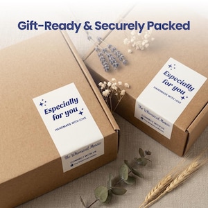 May include: Two brown cardboard boxes with white labels reading Especially for you, HANDMADE WITH LOVE, and The Whimsical Mosaic. The boxes are decorated with sprigs of dried lavender and wheat, and the text Gift-Ready & Securely Packed is visible.