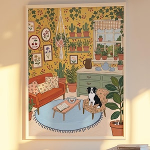 May include: A framed wall art print depicting a cozy living room scene with yellow wallpaper, a red sofa, a blue rug, and a black and white dog sitting on a patterned armchair. The illustration includes potted plants, a window, and a sign reading MON CHERI.