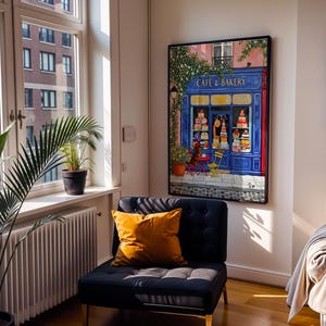 Charming Paris café art print featuring a classic blue storefront on a quaint city street, with a small dog waiting patiently beside a table of pastries. Croissants and coffee add a cozy morning feel, while soft light and European details evoke a relaxed Parisian atmosphere. Elegant yet whimsical wall art perfect for kitchens, cafés, or living spaces, celebrating travel, food, and everyday moments in France.
