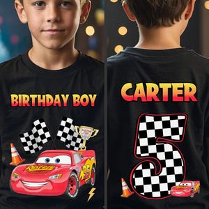 May include: Black t-shirt with a red race car graphic, checkered flags, and the text "BIRTHDAY BOY." The back of the shirt features the name "CARTER" and a large number "5" with a checkered pattern.