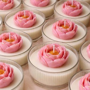 May include: A set of three ceramic mugs with a speckled, matte finish. The mugs are in shades of cream, light gray, and dark gray. Each mug has a simple, minimalist design and a rounded handle.