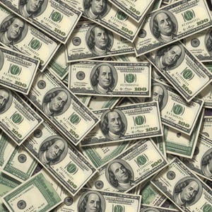 May include: A full-frame image of scattered United States one hundred dollar bills. The bills are green and white, featuring a portrait of Benjamin Franklin and the number 100.