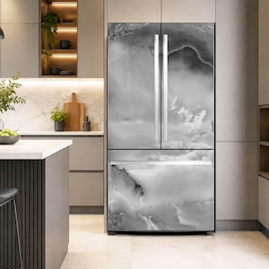 May include: A French door refrigerator featuring a smooth, glossy finish with a monochromatic gray and white abstract marble pattern. The appliance has two vertical doors on top and a single pull-out freezer drawer at the bottom with silver handles.