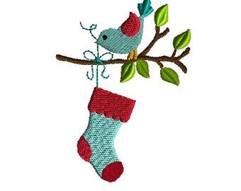 May include: An embroidery design featuring a light blue bird with a red wing perched on a brown branch with green leaves. The bird holds a teal string attached to a light blue Christmas stocking with a red cuff, heel, and toe section.