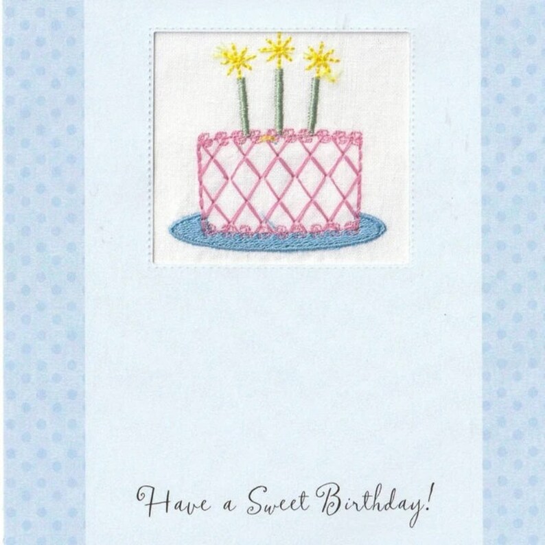 May include: A light blue card with a white border and a pink and blue embroidered cake with three yellow candles. The text "Have a Sweet Birthday!" is written in cursive at the bottom of the card.