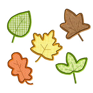 May include: Five embroidered leaf designs in green, yellow, orange, and brown. Each leaf features a unique pattern, including gingham, circles, and textured fabric, with detailed stitching.
