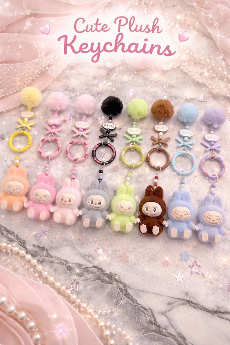 May include: A collection of plush keychains in various colors, including peach, pink, gray, and brown. Each keychain features a bunny-like character with a pom-pom and decorative accents. The text "Cute Plush Keychains" is visible.